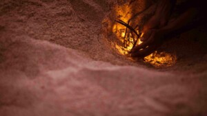 tourist makes a fire on the beach